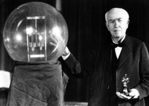 Thomas A. Edison seen here in 1929 holding a replica of his first lamp.